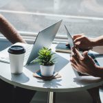 Two men at table meeting with laptop