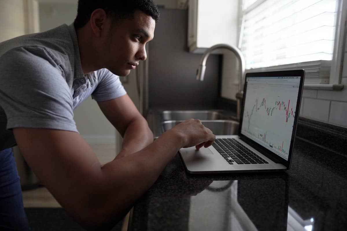 a man analyzing data on laptop