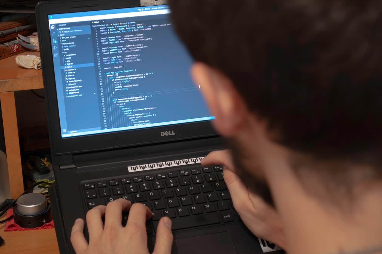 a man coding on his laptop