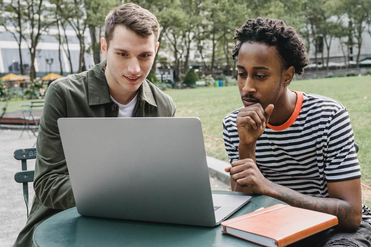 two men looking at laptop