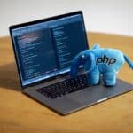 PHP Plush Elephant toy on a Macbook Pro with code on the screen