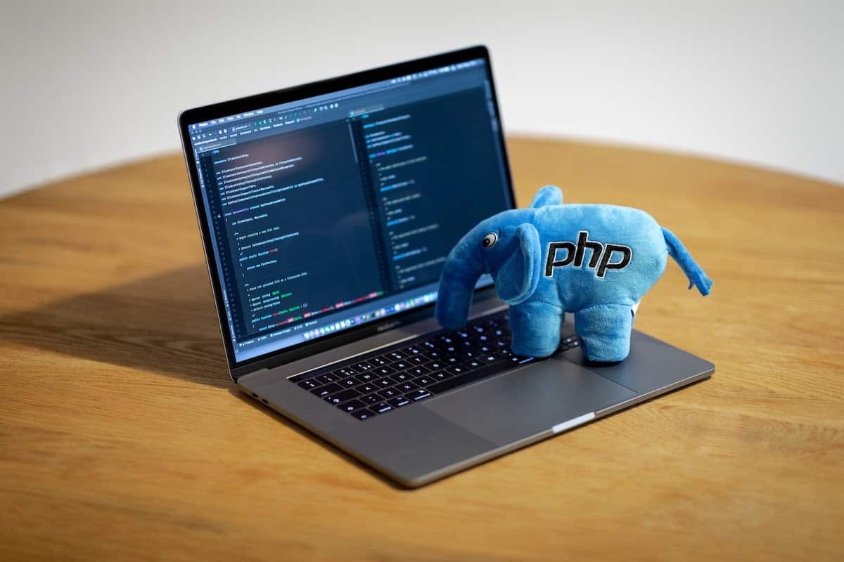 PHP Plush Elephant toy on a Macbook Pro with code on the screen