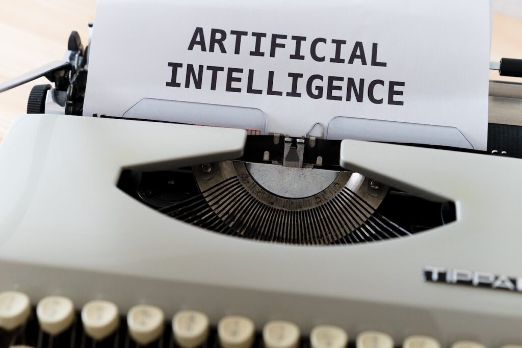 a photo of a white and black typewriter with artificial intelligence written on it