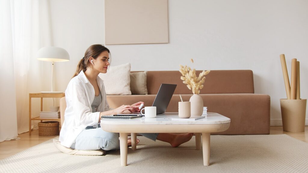 A lady researching on her computer at home