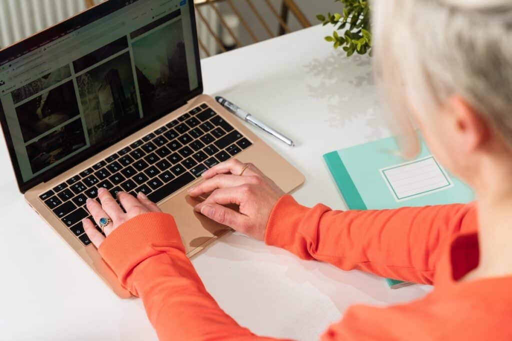 Person coding a website on a MacBook at a desk How to Code a Website