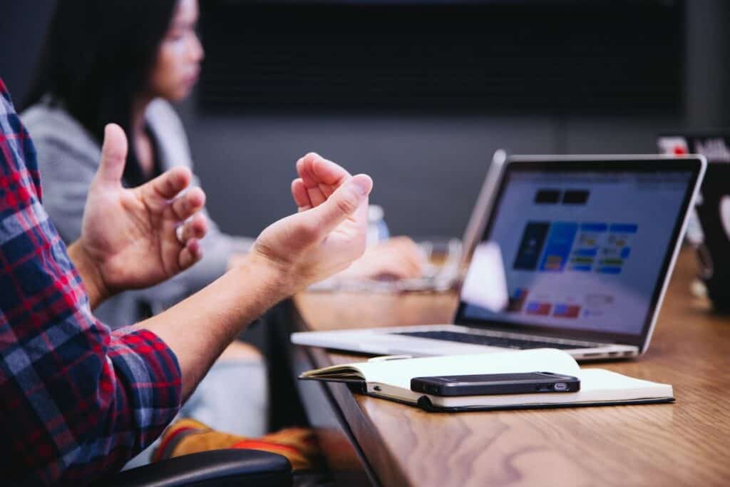 A tech employee explains a concept in a meeting. Getting a Job After a Coding Bootcamp