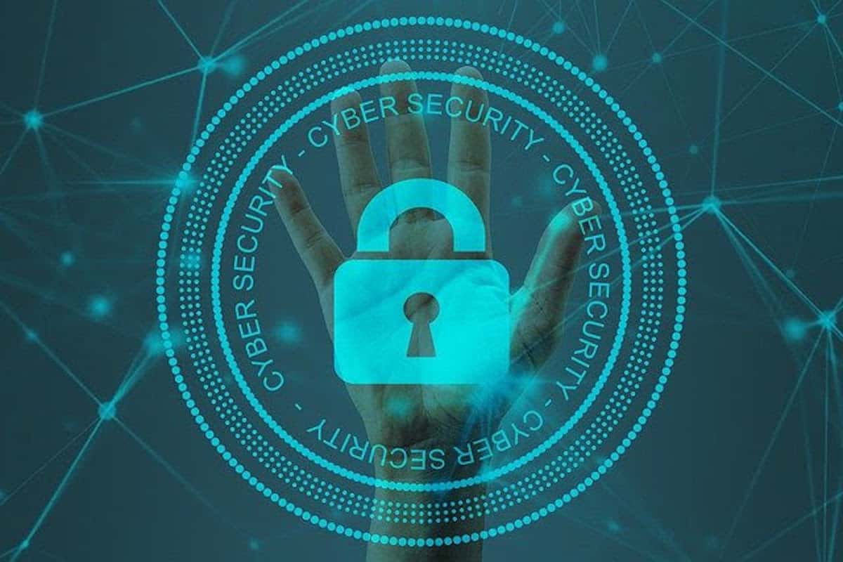 A picture of a circle with a lock and cyber security written on it with a background of a hand cybersecurity vs computer science