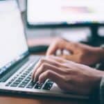 Man looking up job outlook statistics on his laptop