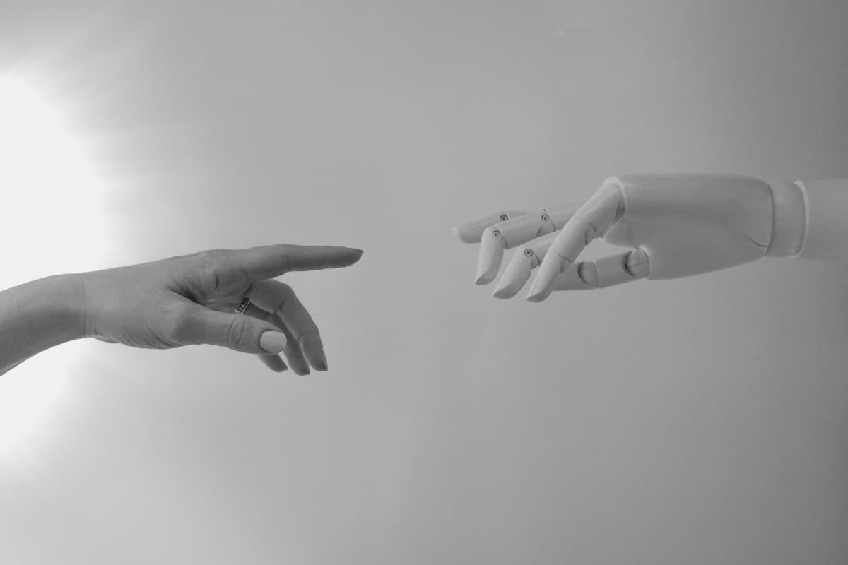 A human hand reaching out to a robot’s hand