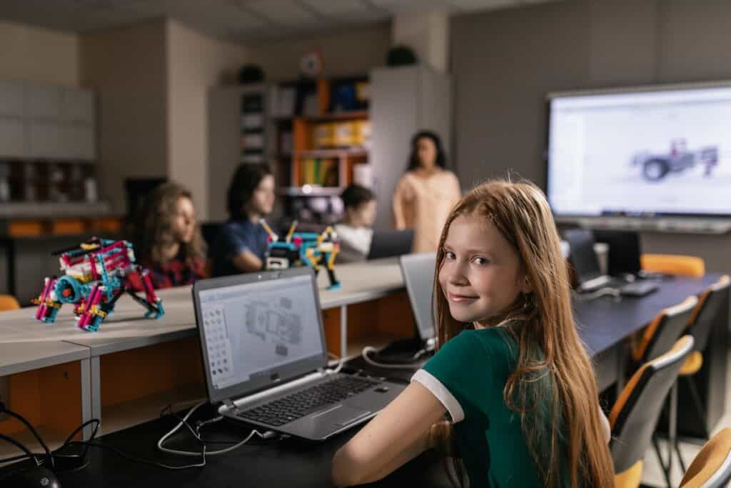A child in robotics class sitting at a computer