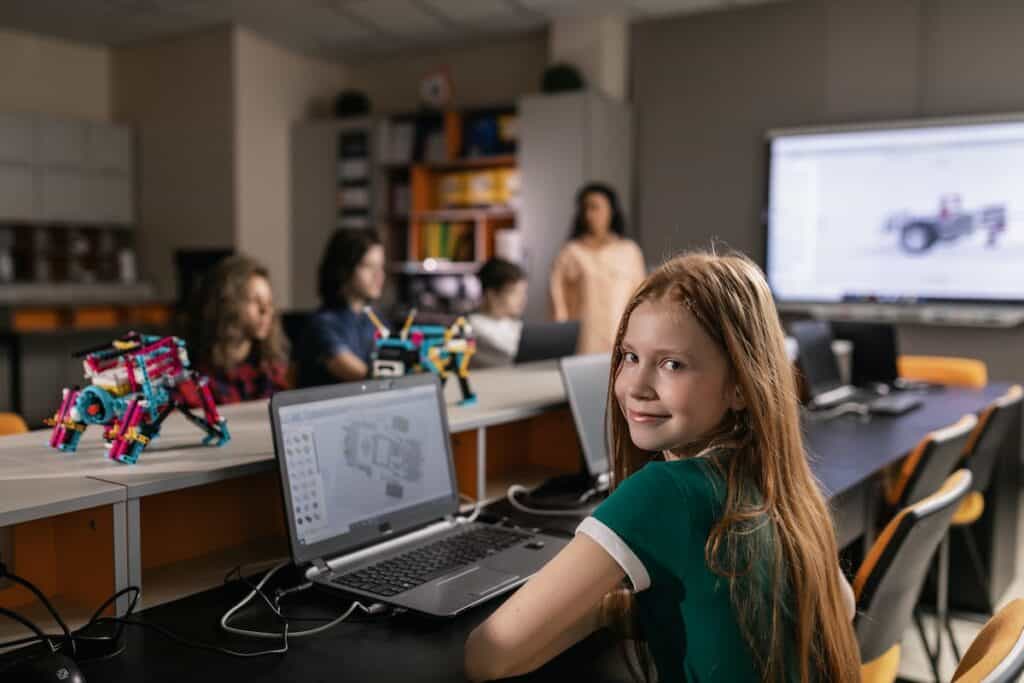 A child in robotics class sitting at a computer
